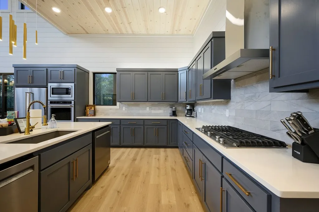 Kitchen at The Arcadia showing gray cabinetry, coffee station area, and shiplap walls with horse artwork