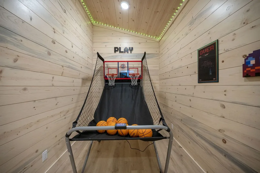 Indoor basketball shootout game with PLAY sign in wood-paneled game room at The Arcadia