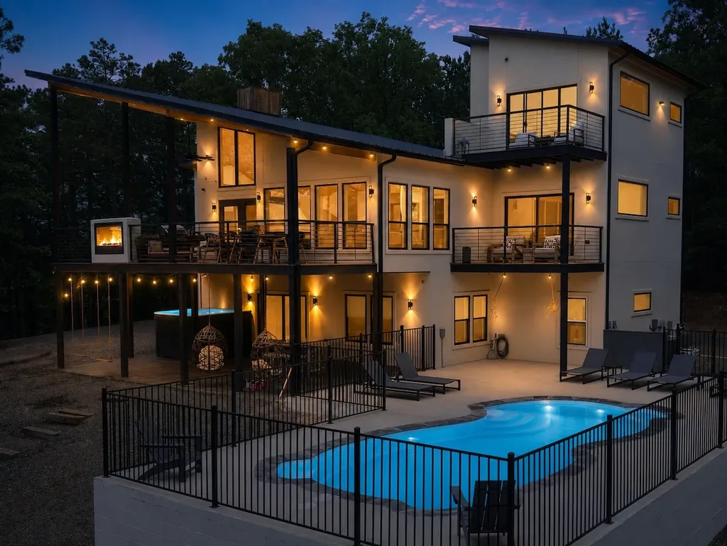 Rear exterior and private heated pool at The Aroha at twilight