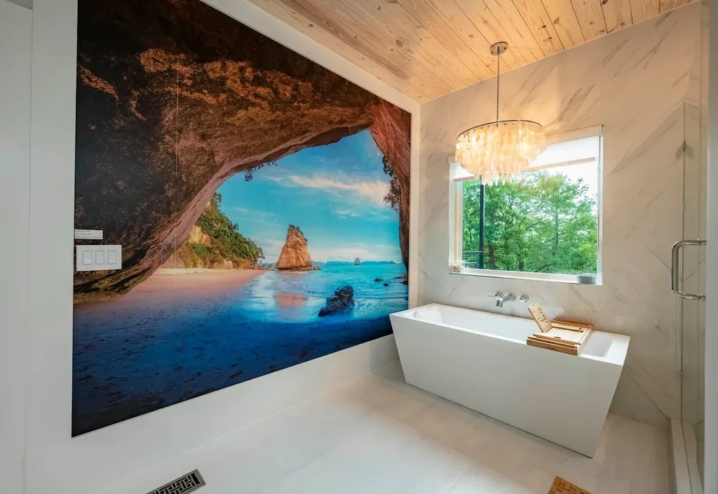 Spa bathroom tub with New Zealand mural at The Aroha