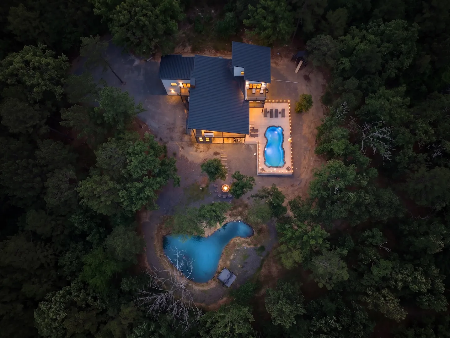 Aerial view of The Aroha showing the heated pool and pond across 4.5 wooded acres
