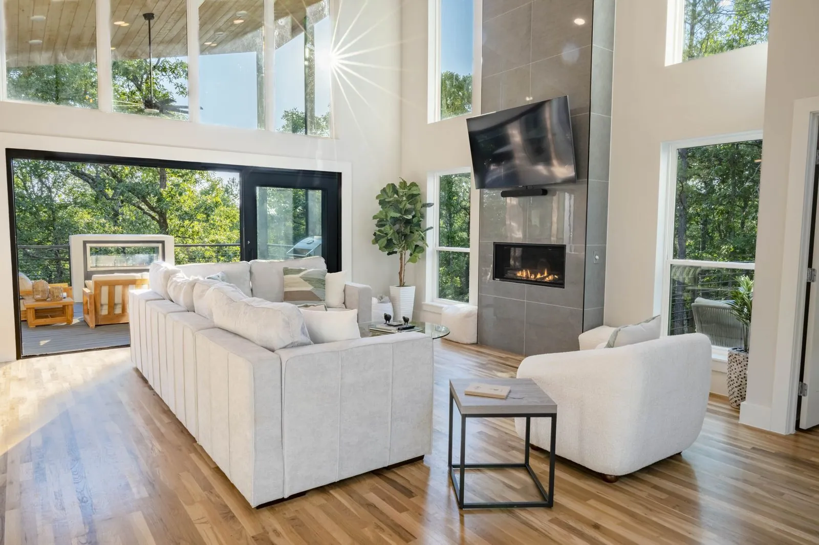 Dual-sided linear fireplace at The Aroha visible from both interior and exterior through glass walls