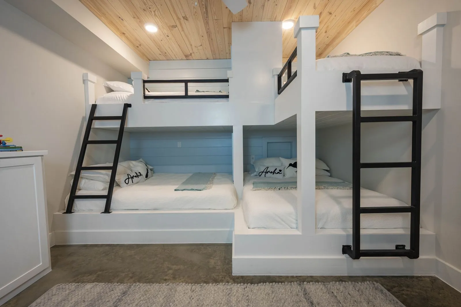 Bedroom at The Aroha with king bed, TV, and sightline to ensuite bathroom