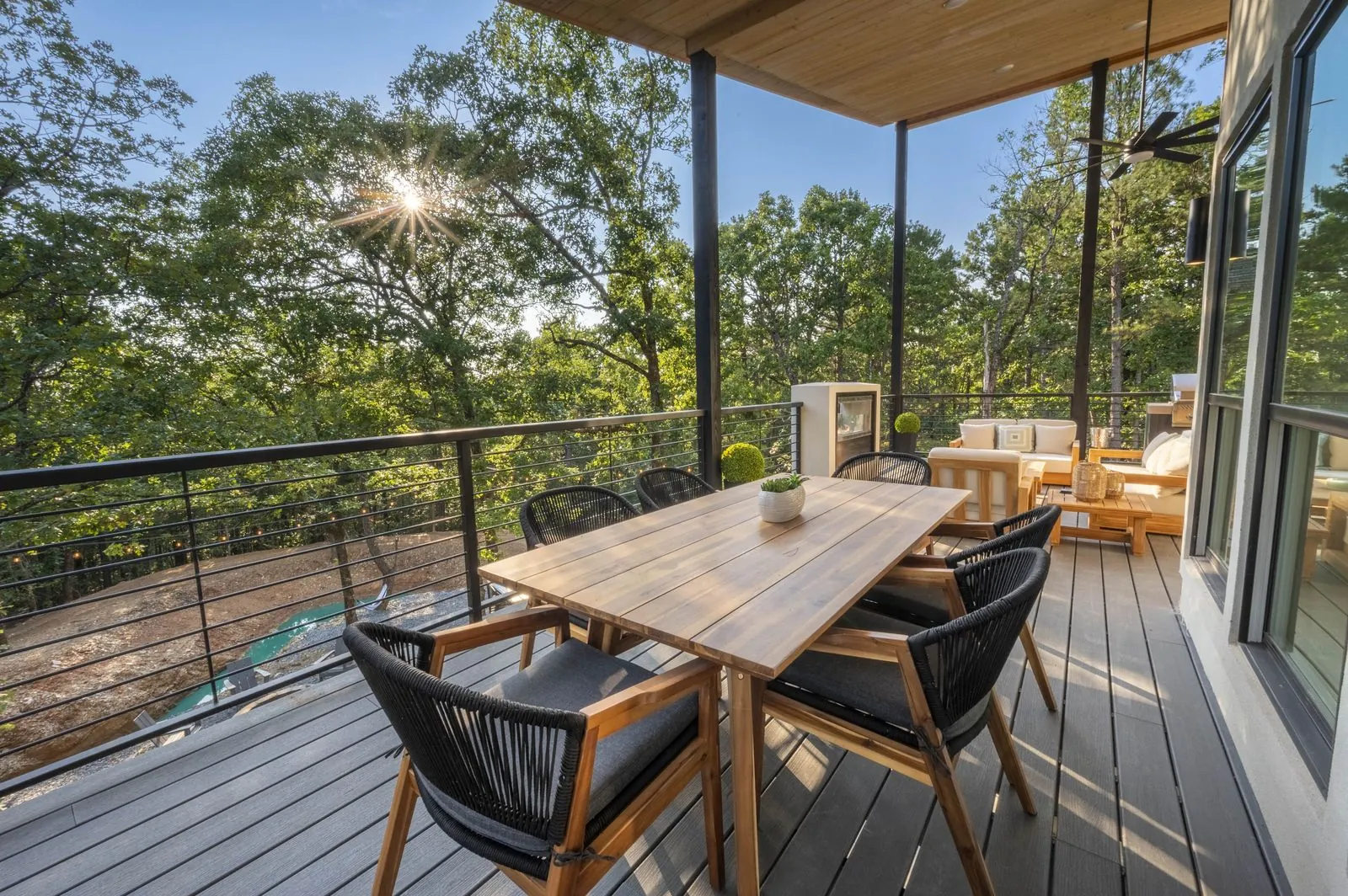 Open-concept great room at The Aroha with slatted wood ceiling, kitchen island, and living area
