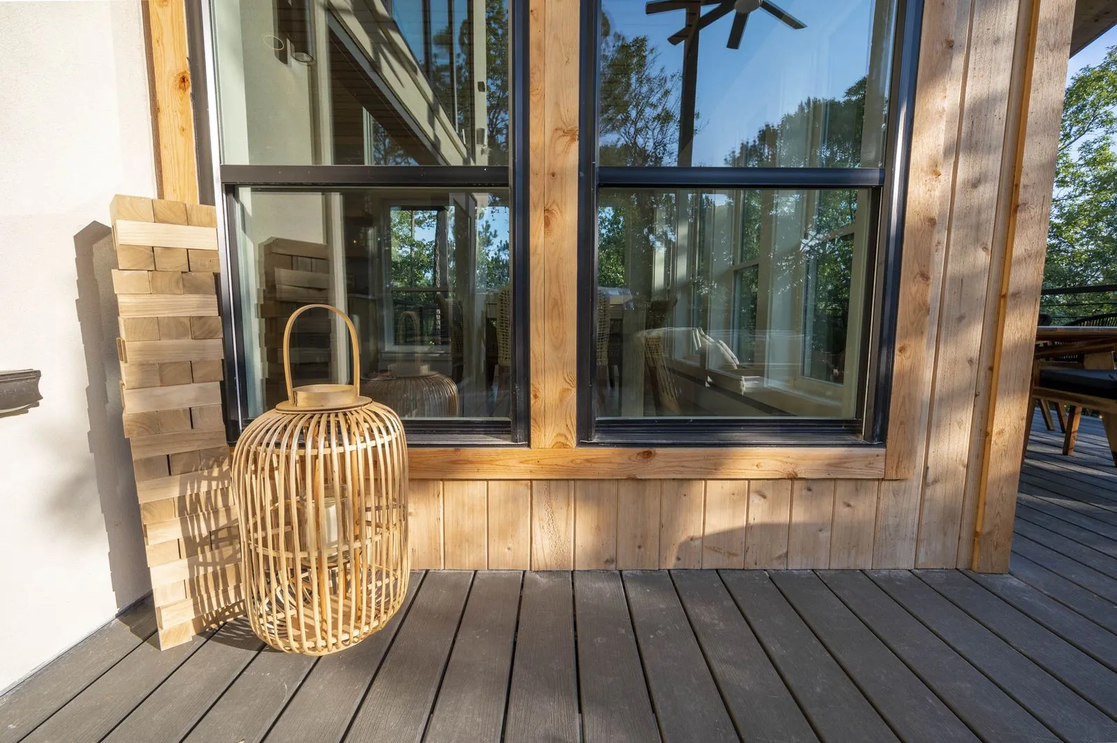 Upper deck with teak lounge chairs at The Aroha overlooking the forest at sunset