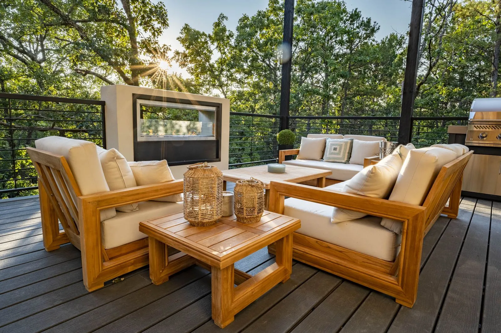 Upper deck teak lounge seating at The Aroha with treetop views and string lights