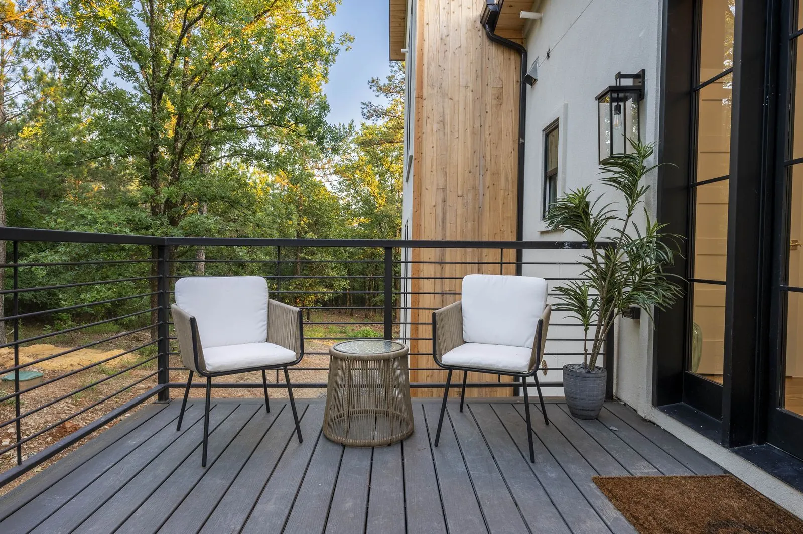 Front exterior of The Aroha at twilight with fire pit glow and Adirondack chairs in foreground