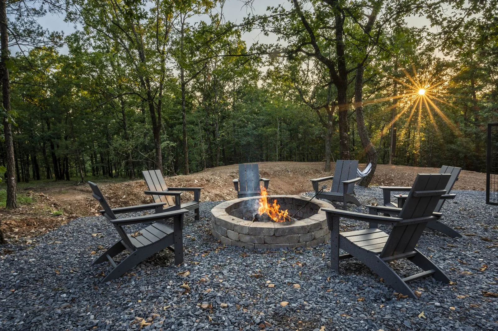 Fire pit with Adirondack chairs at The Aroha