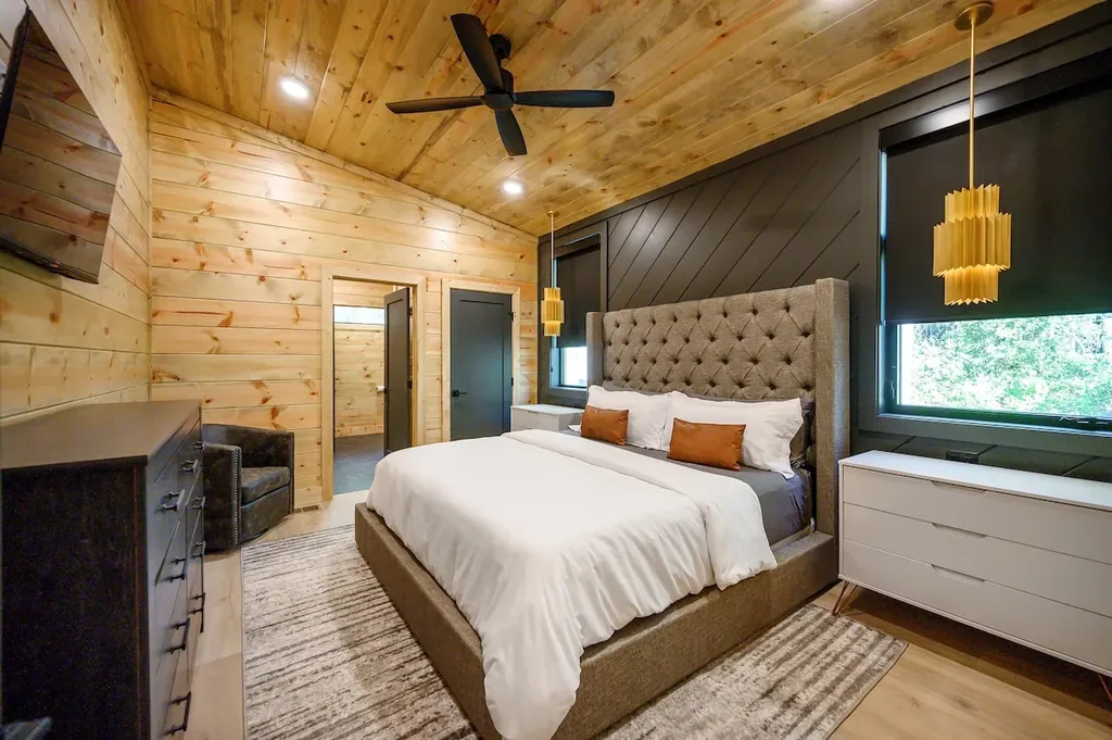King Bedroom 3 with tufted bed and gold pendant lights