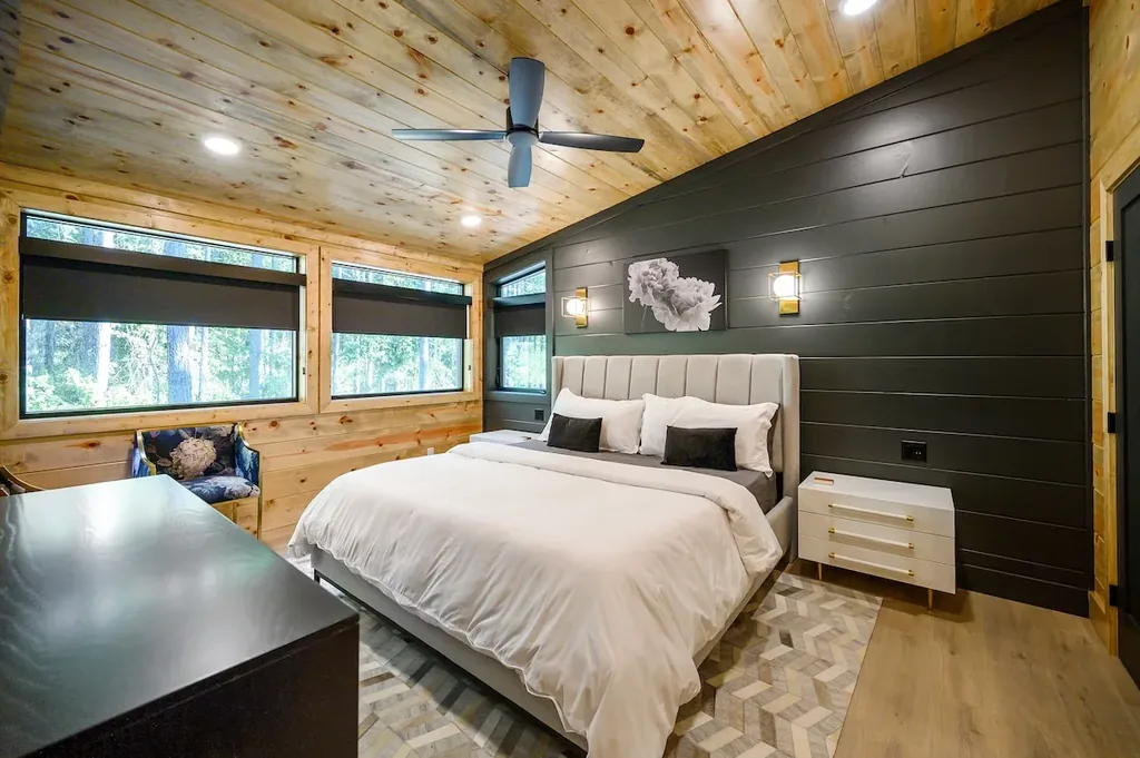 King Bedroom 4 with forest-view windows and dark feature wall