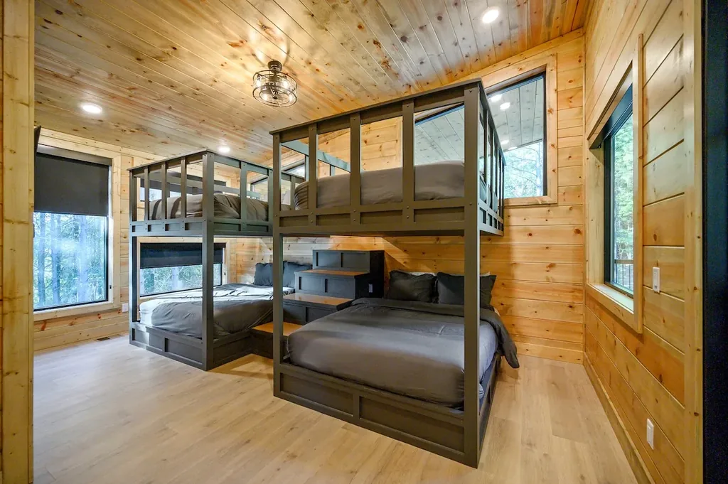 Bunk room with two built-in bunk beds and storage stairs