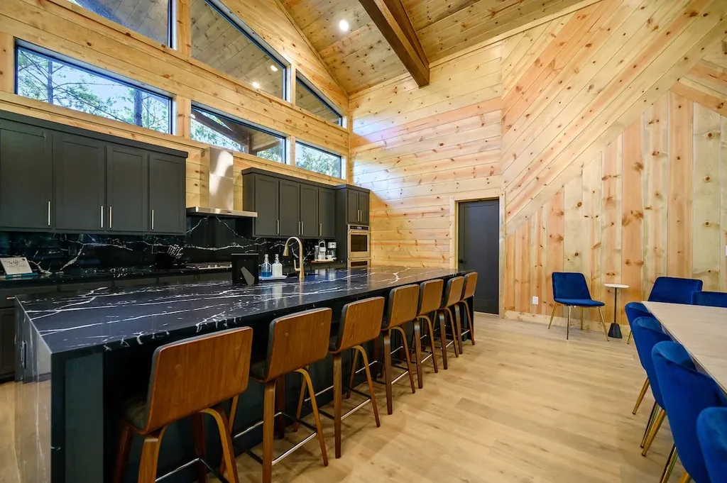 Chef's kitchen with black marble island and counter seating