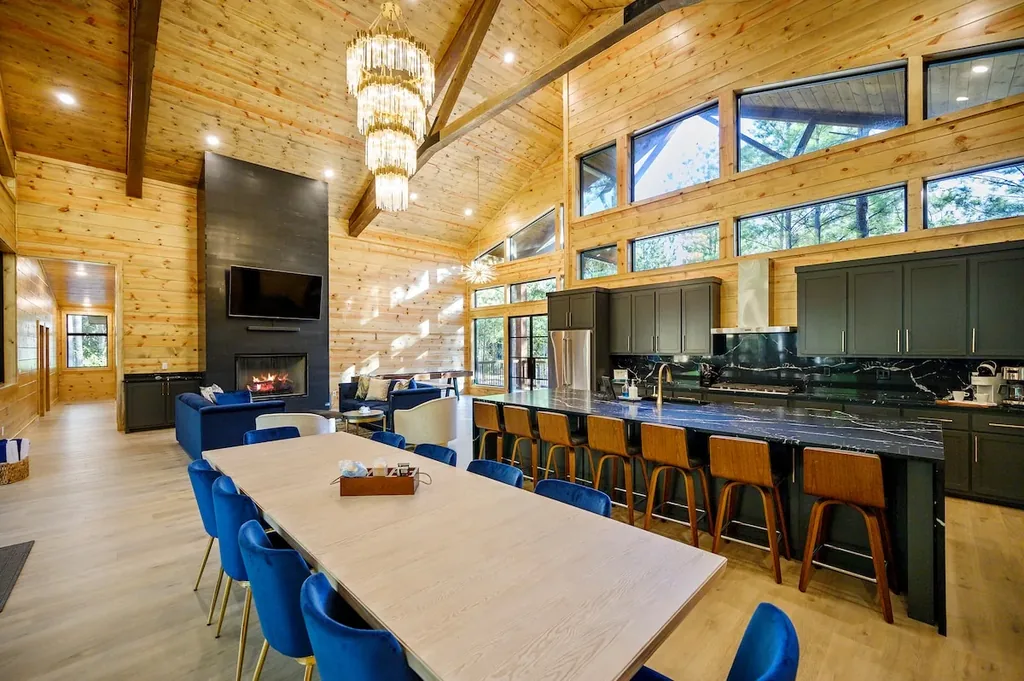 Open dining area beside the kitchen and tall forest windows