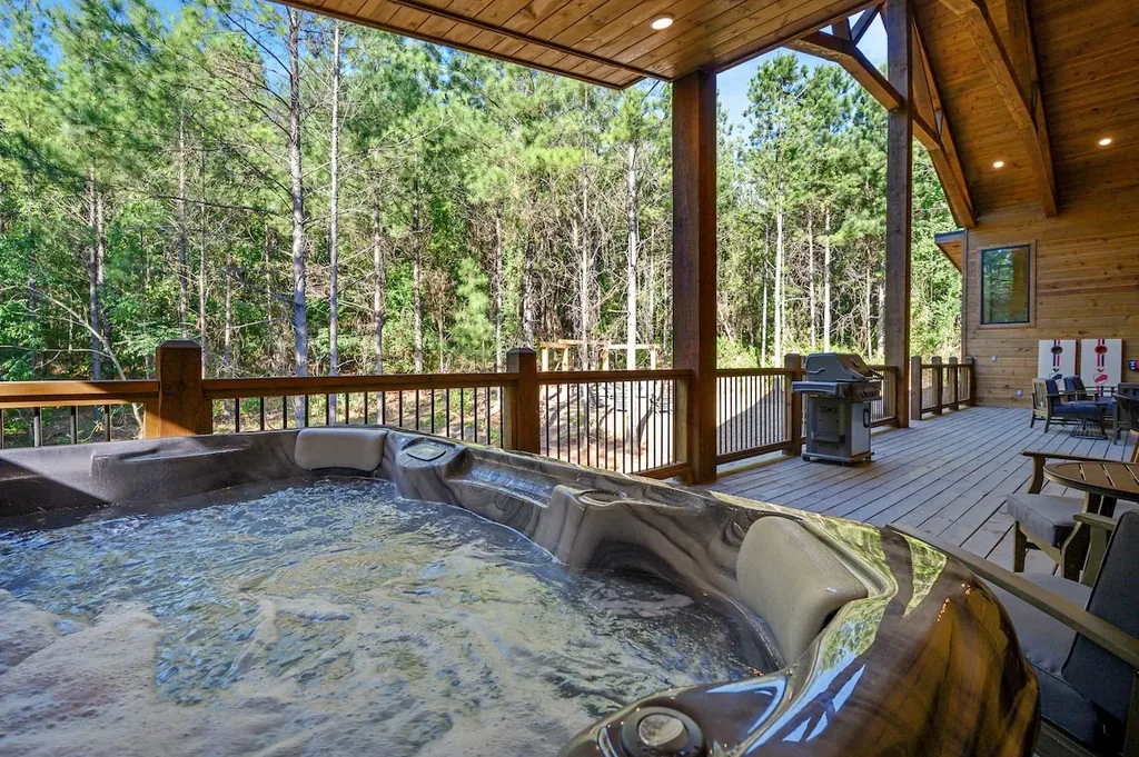 Private hot tub on the covered deck overlooking the forest