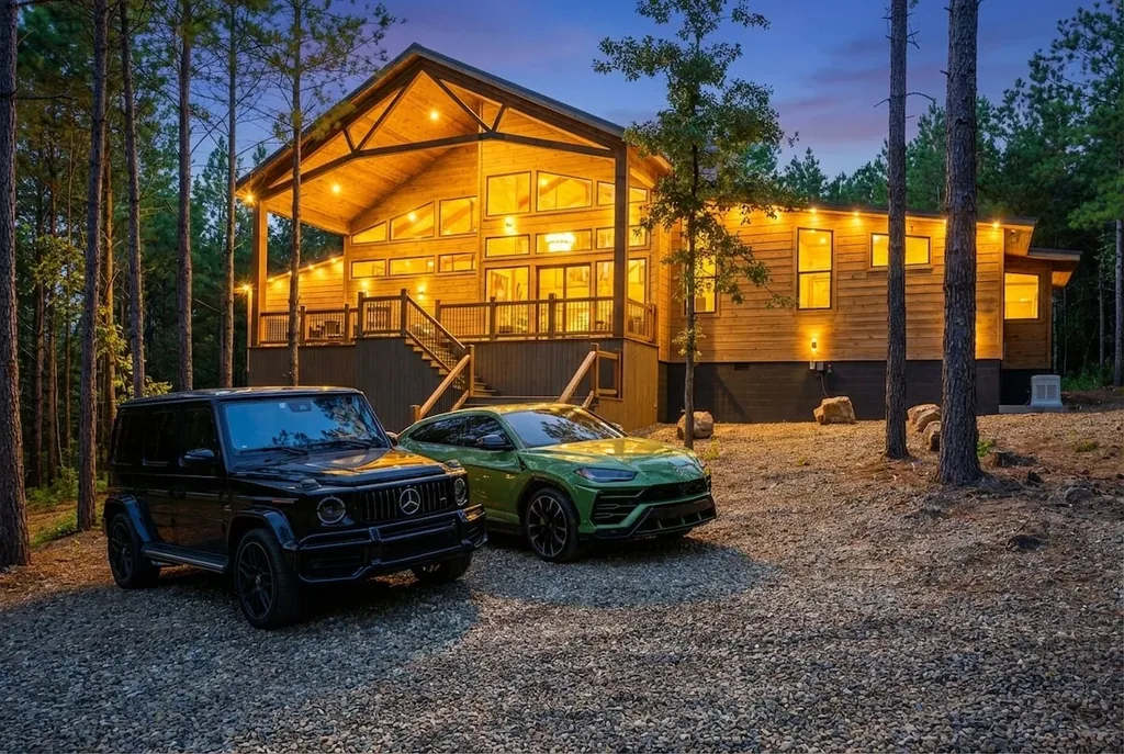 The Avalon exterior glowing at dusk with vehicles in the driveway