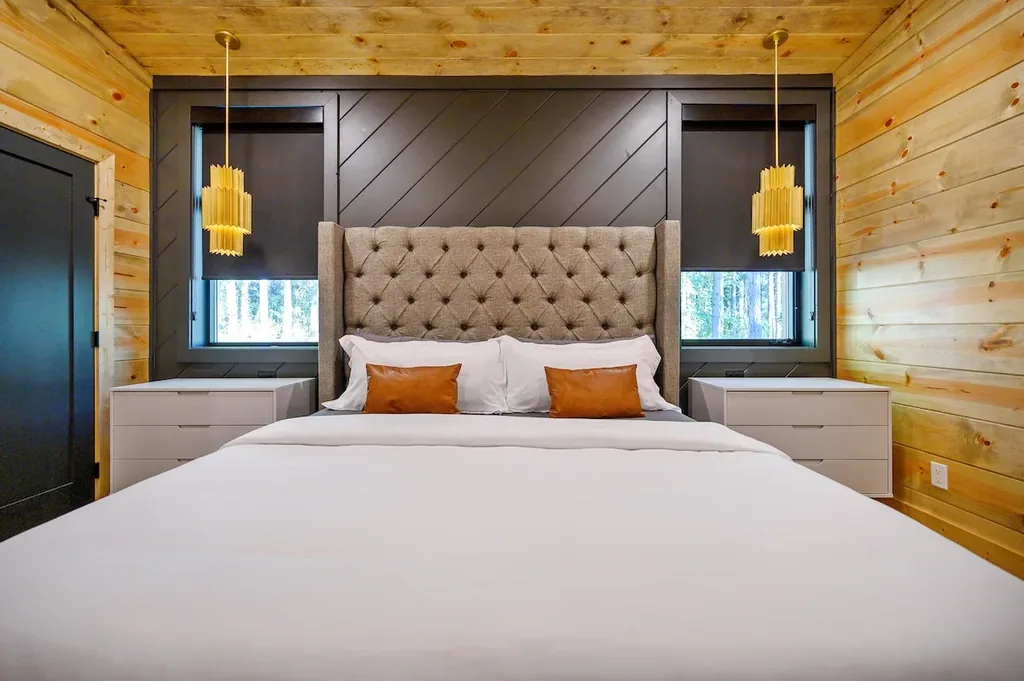 King Bedroom 3 with tufted headboard and gold pendants