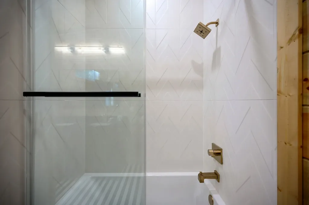 Full Bathroom 5 glass shower with white tile and gold fixtures