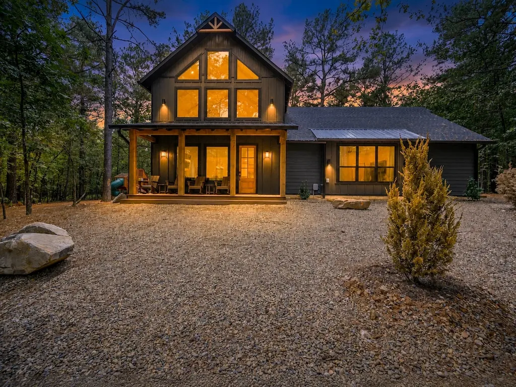 The Black-Beary — A private wooded setting and a warmly lit two-story facade set the tone before guests even step inside.