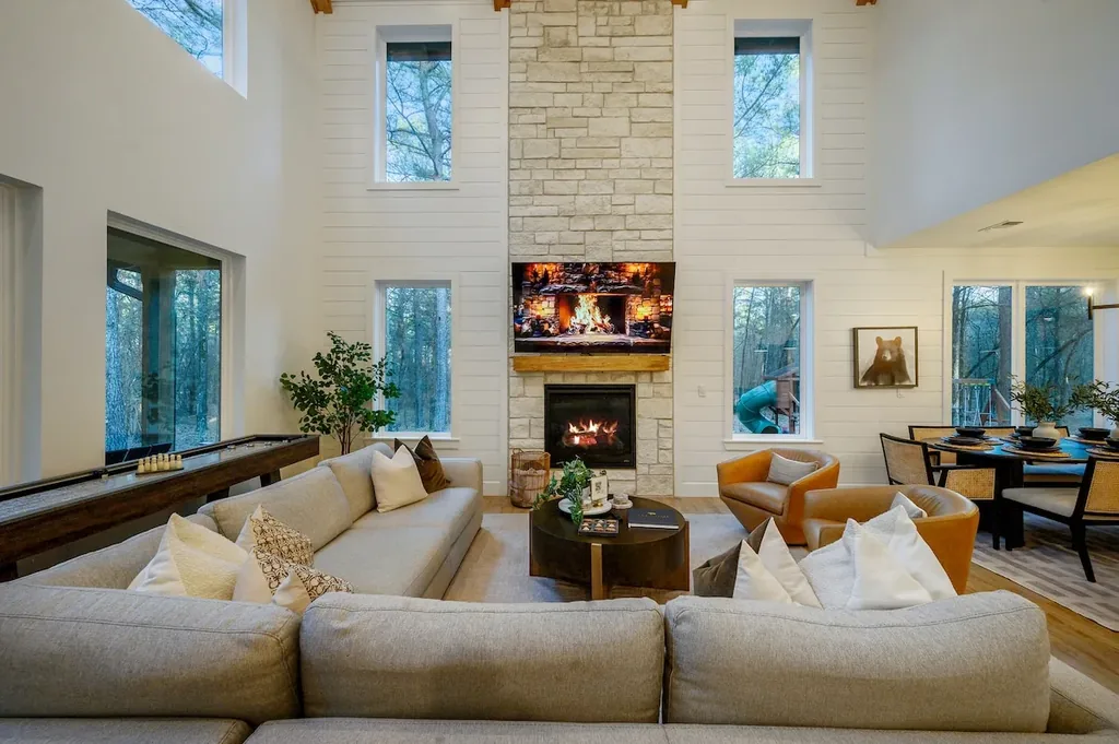 The Black-Beary — Gather around the stone fireplace in a soaring two-story living room with room to lounge, play shuffleboard, and dine together.