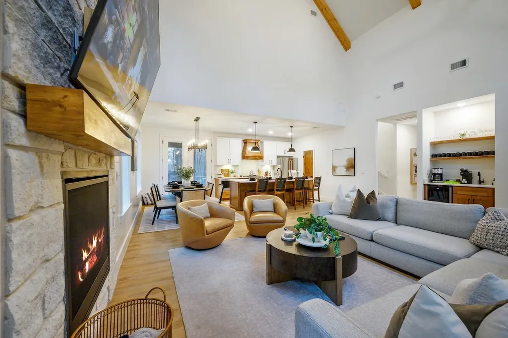 The Black-Beary — Gather around the stone fireplace in this open-concept living space that flows straight into the dining area and kitchen.