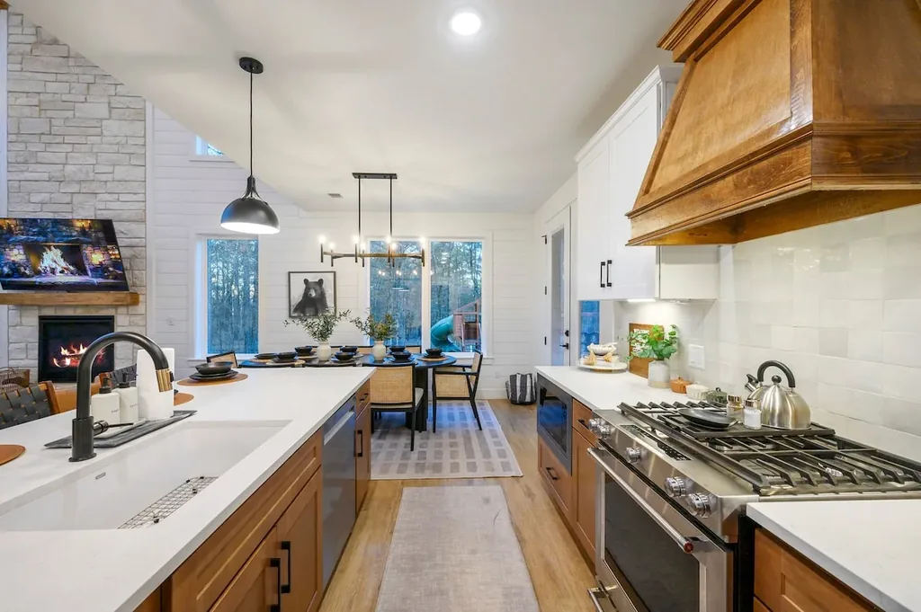 The Black-Beary — Cook and gather in one open space, with a gas range and island counter that flow straight into the dining table.
