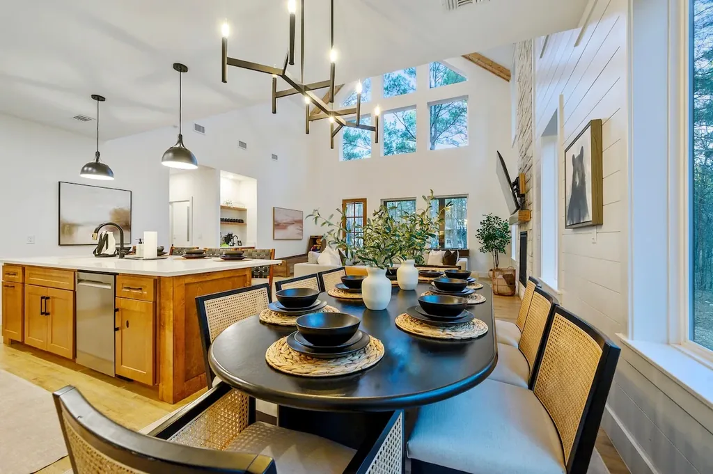 The Black-Beary — High ceilings and a wall of windows fill this open dining and kitchen space with natural light, ideal for group meals.