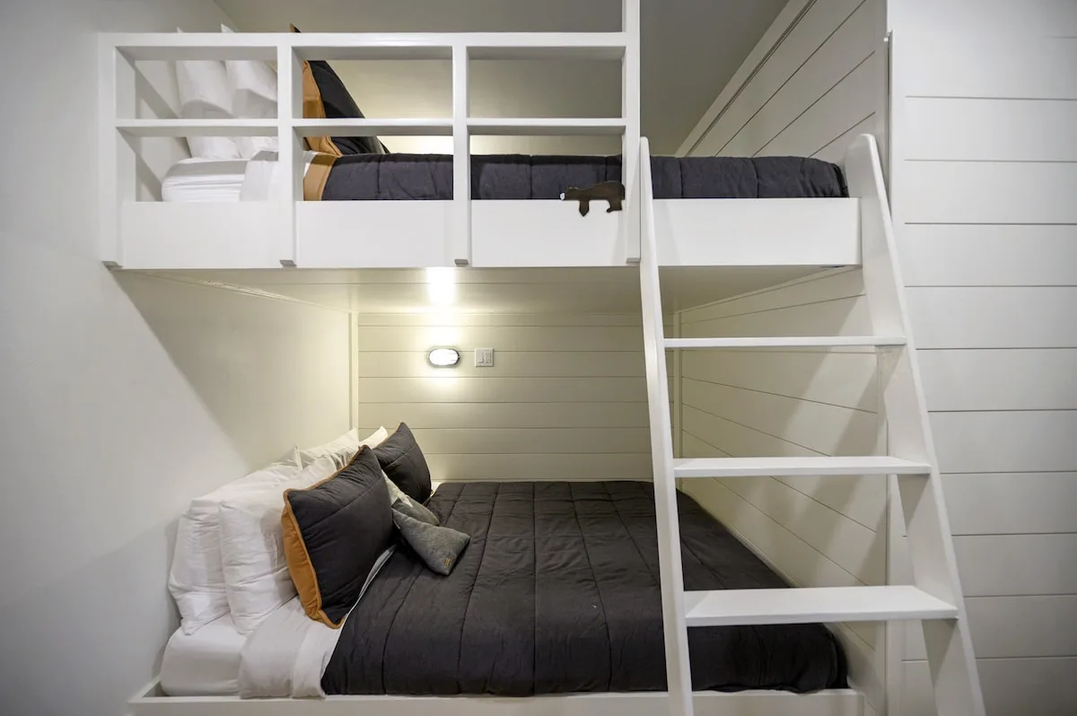 Built-in queen-over-queen bunks with tree views