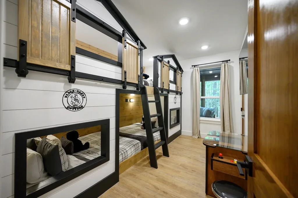 The Black-Beary — A playful built-in bunk room with barn-door bed nooks and a tabletop arcade game gives kids their own space to sleep and play.