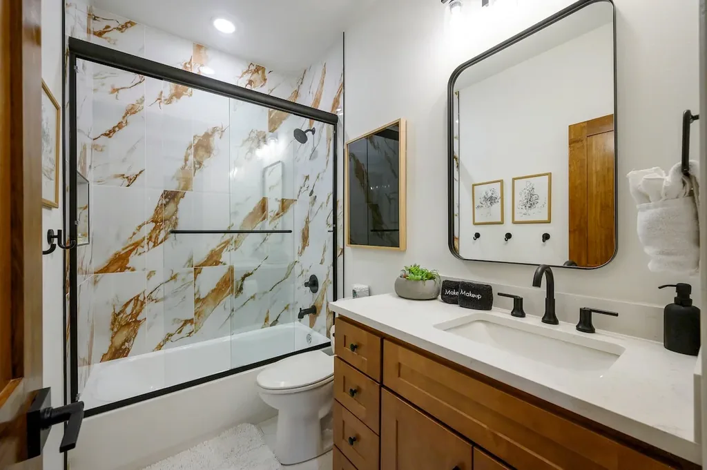 Vanity and walk-in shower in full bathroom 3