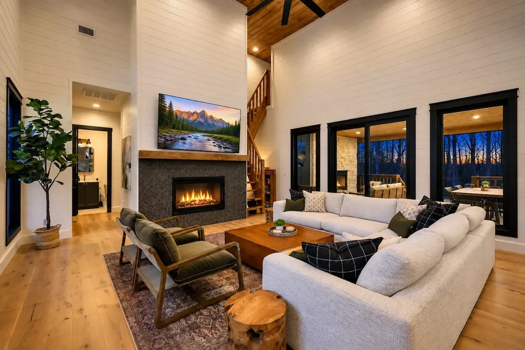 Open living room at Blue Note with fireplace and wall of windows