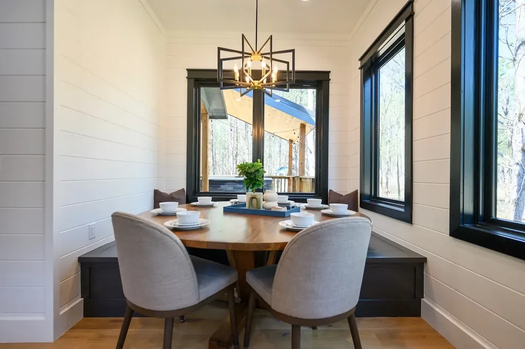 Blue Note dining table beside windows overlooking the woods
