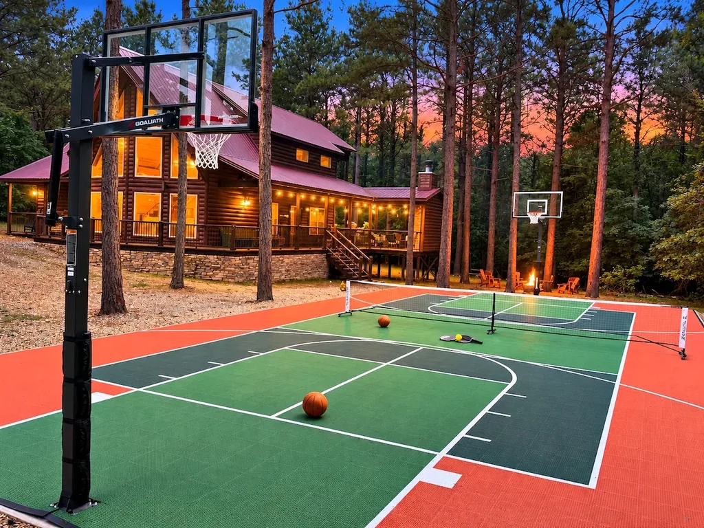 Cami's Campout cabin and private pickleball and basketball court at dusk