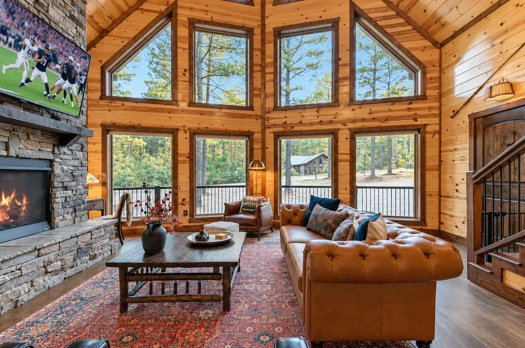 Cami's Campout living room with leather seating and pine views