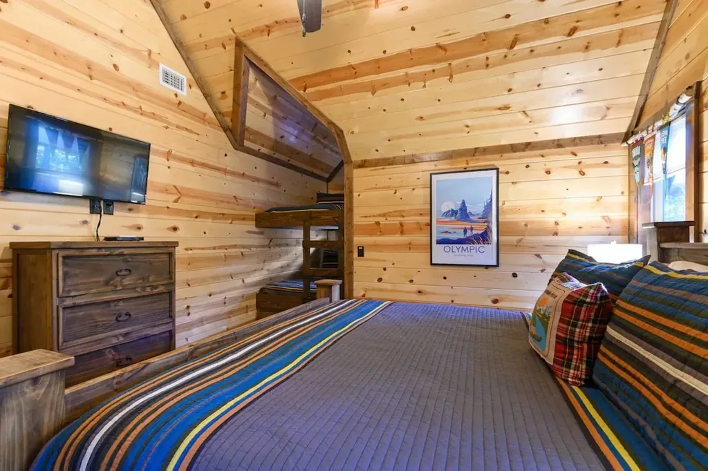 Television and dresser in the upstairs king bedroom at Cami's Campout