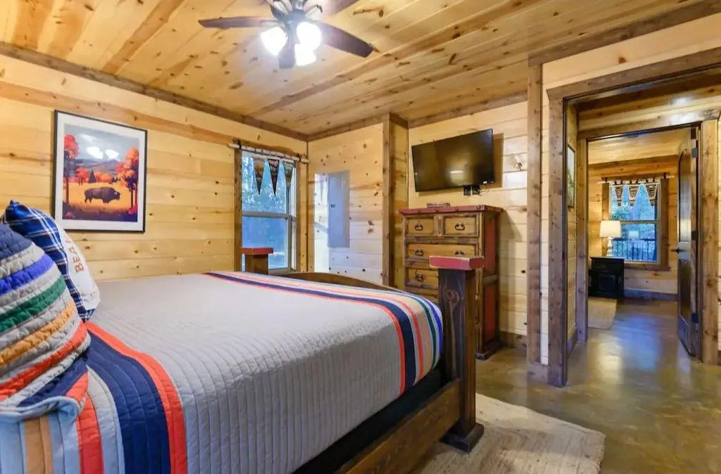 Main-floor king bedroom 2 with television at Cami's Campout