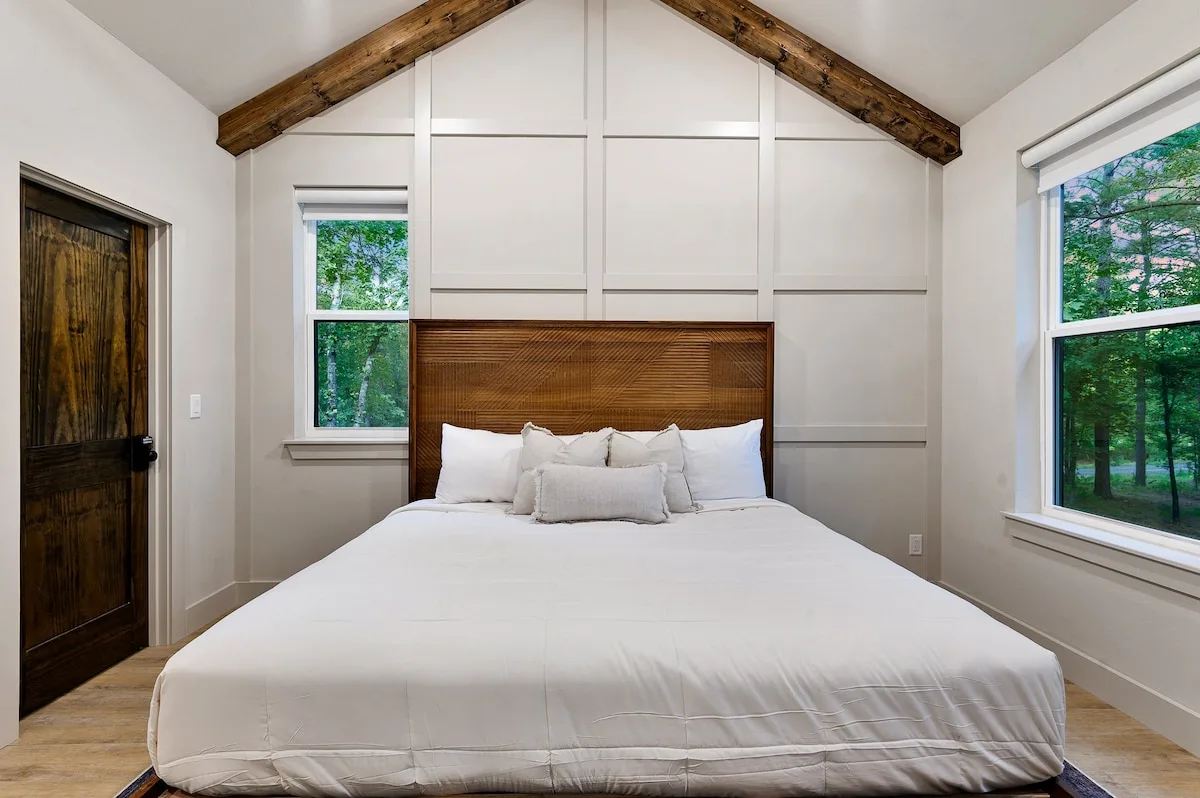 Primary king bedroom with forest views at DOLCE FAR NIENT