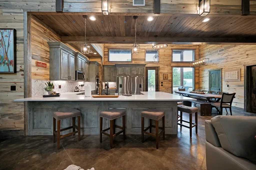 Full kitchen with island seating and adjacent dining room