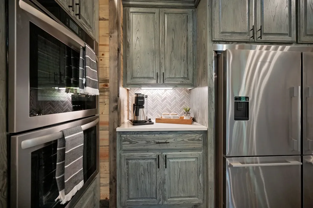 Double ovens, coffee station, and refrigerator in the full kitchen