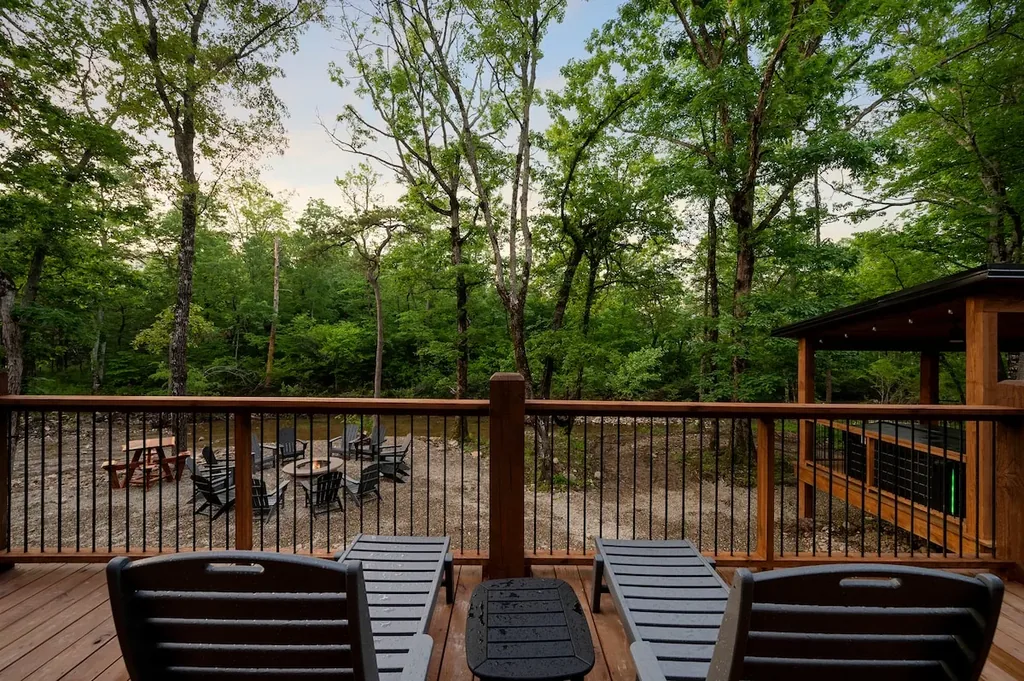 Deck seating overlooking the creekside fire pit and hot-tub pavilion