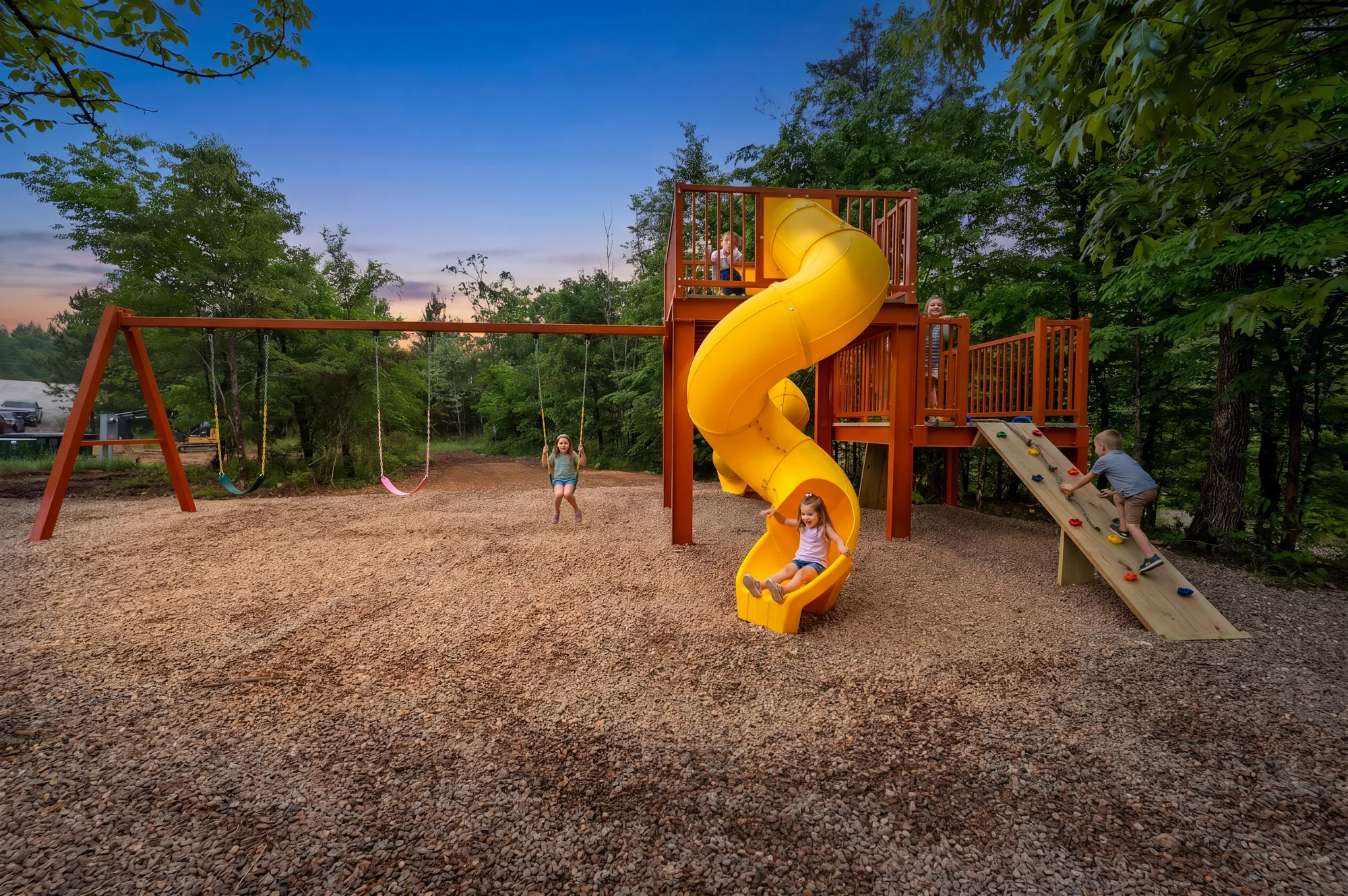 Custom playground with rock wall, swings, and slides at Dreams & Streams