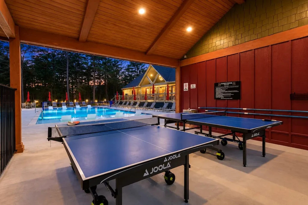 Covered ping pong tables sit next to the Three Creeks Reserve community pool and clubhouse, a shared resort amenity included at no extra cost.