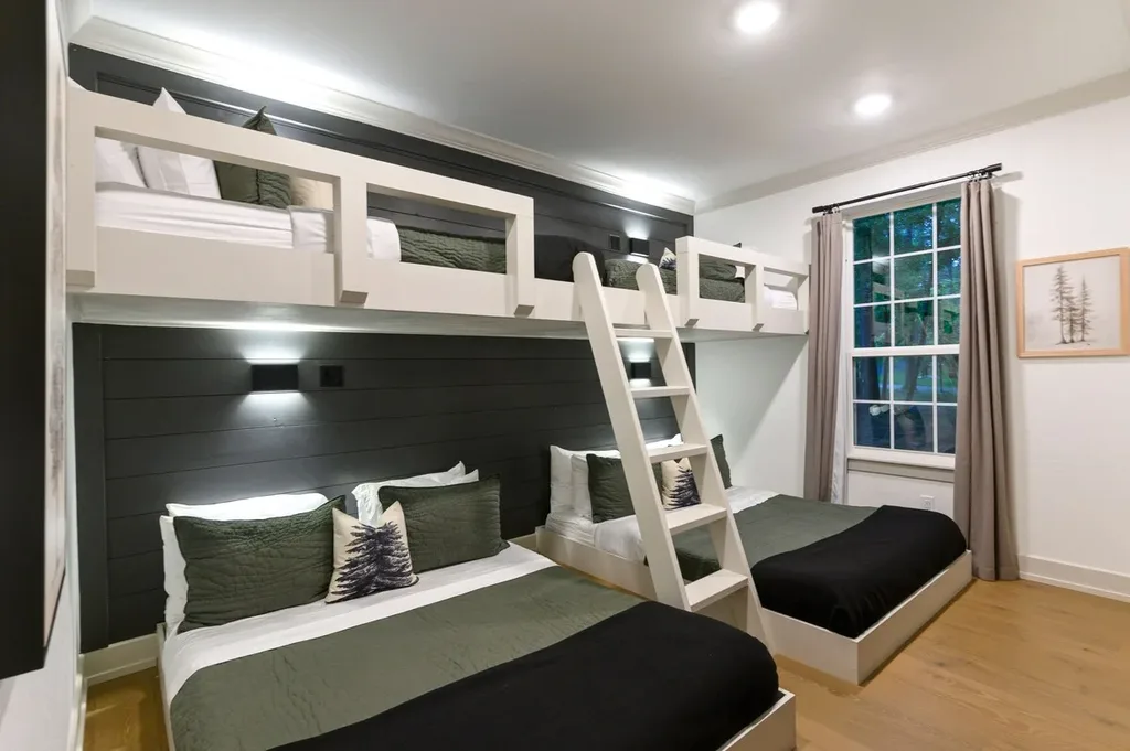 The bunk room sleeps up to six with two queen beds and two twin beds, built-in bunks with a ladder, and a full bathroom just across the hall.