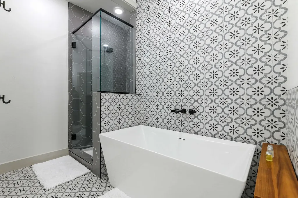 Soak in the freestanding tub or rinse off in the hexagon-tiled walk-in shower, both private to this king suite's ensuite bathroom.