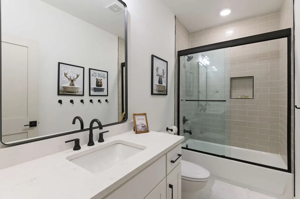 Fourth full bathroom with vanity and glass-enclosed shower at Eleven:Eleven