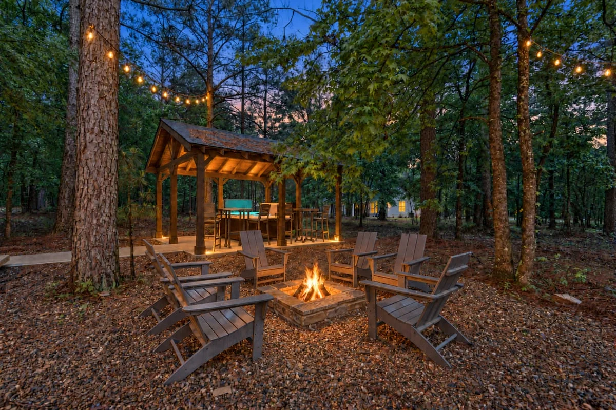 Private hot tub cabana and fire pit in the wooded backyard at Eleven:Eleven