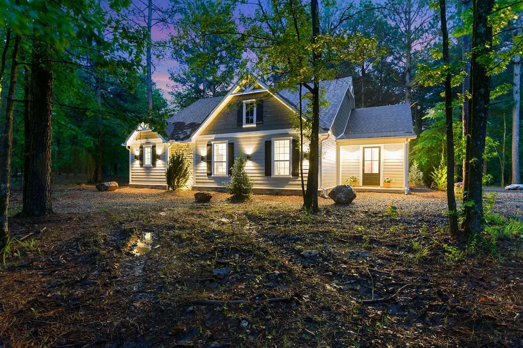 Eleven:Eleven cabin and front porch illuminated at dusk