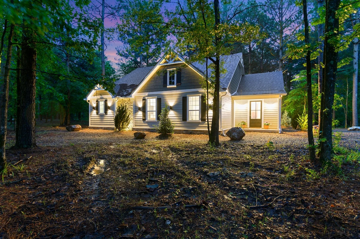 Eleven:Eleven cabin and front porch illuminated at dusk