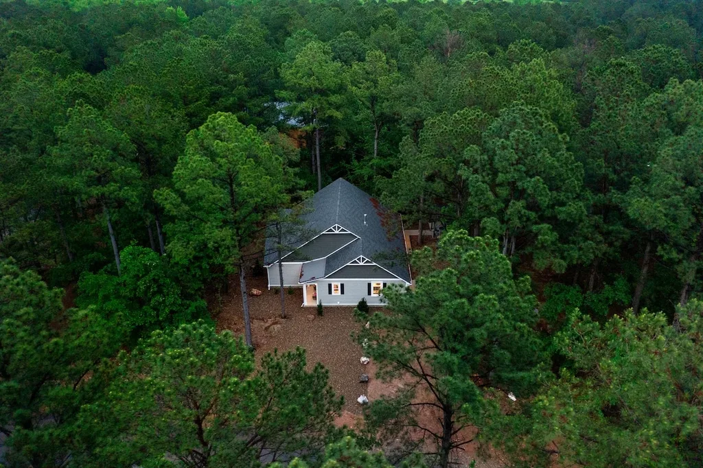 Aerial view of Eleven:Eleven and its wooded setting