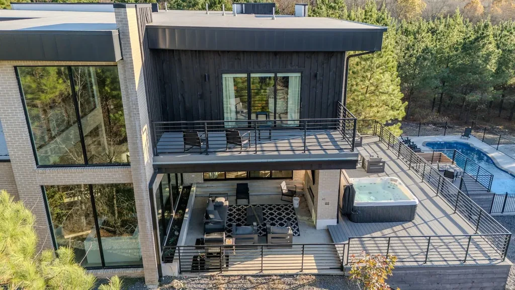 Rear exterior view of The Jade's decks, hot tub, and pool area