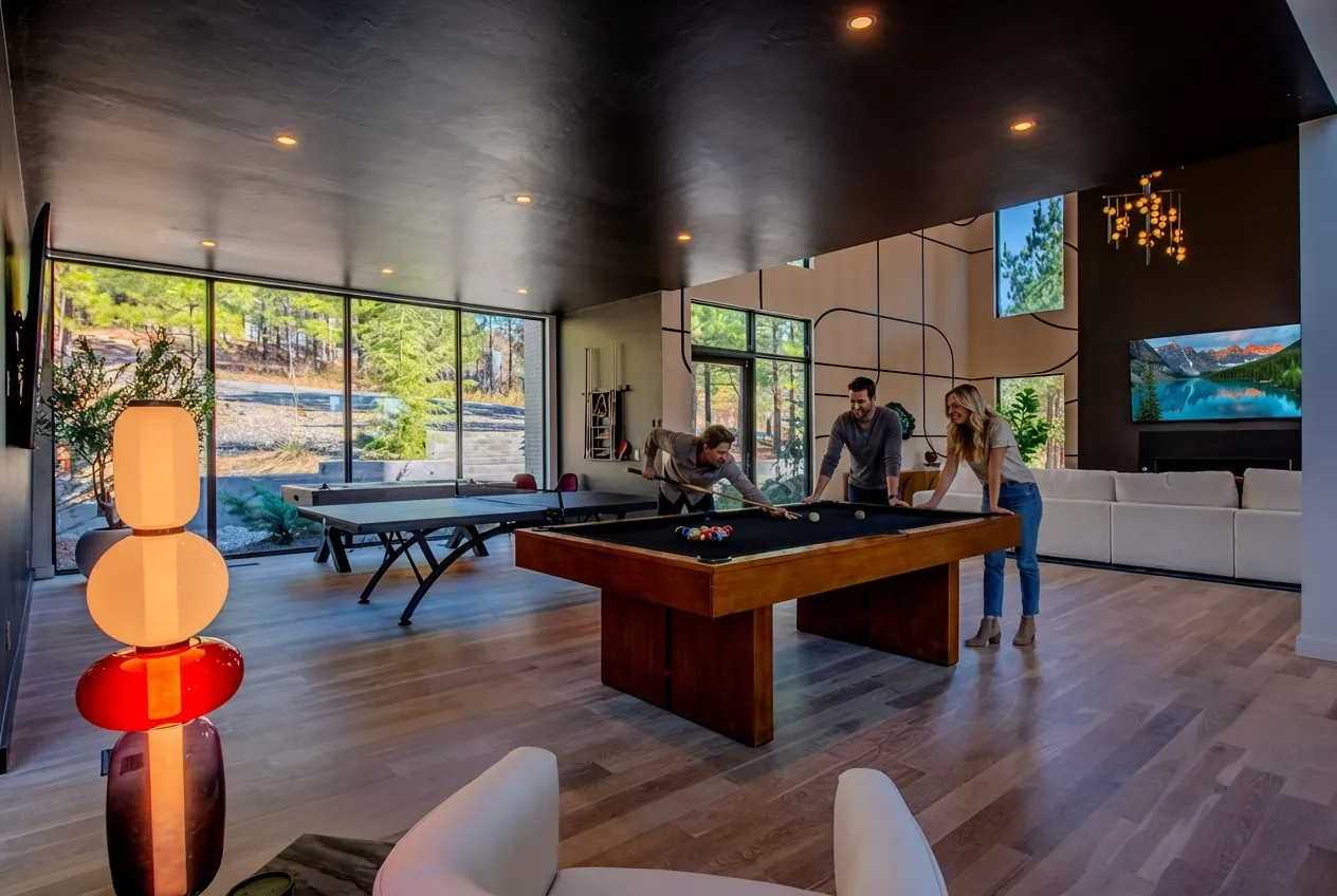 Game area at The Jade with custom pool table, orange art glass floor lamp, and guests playing billiards